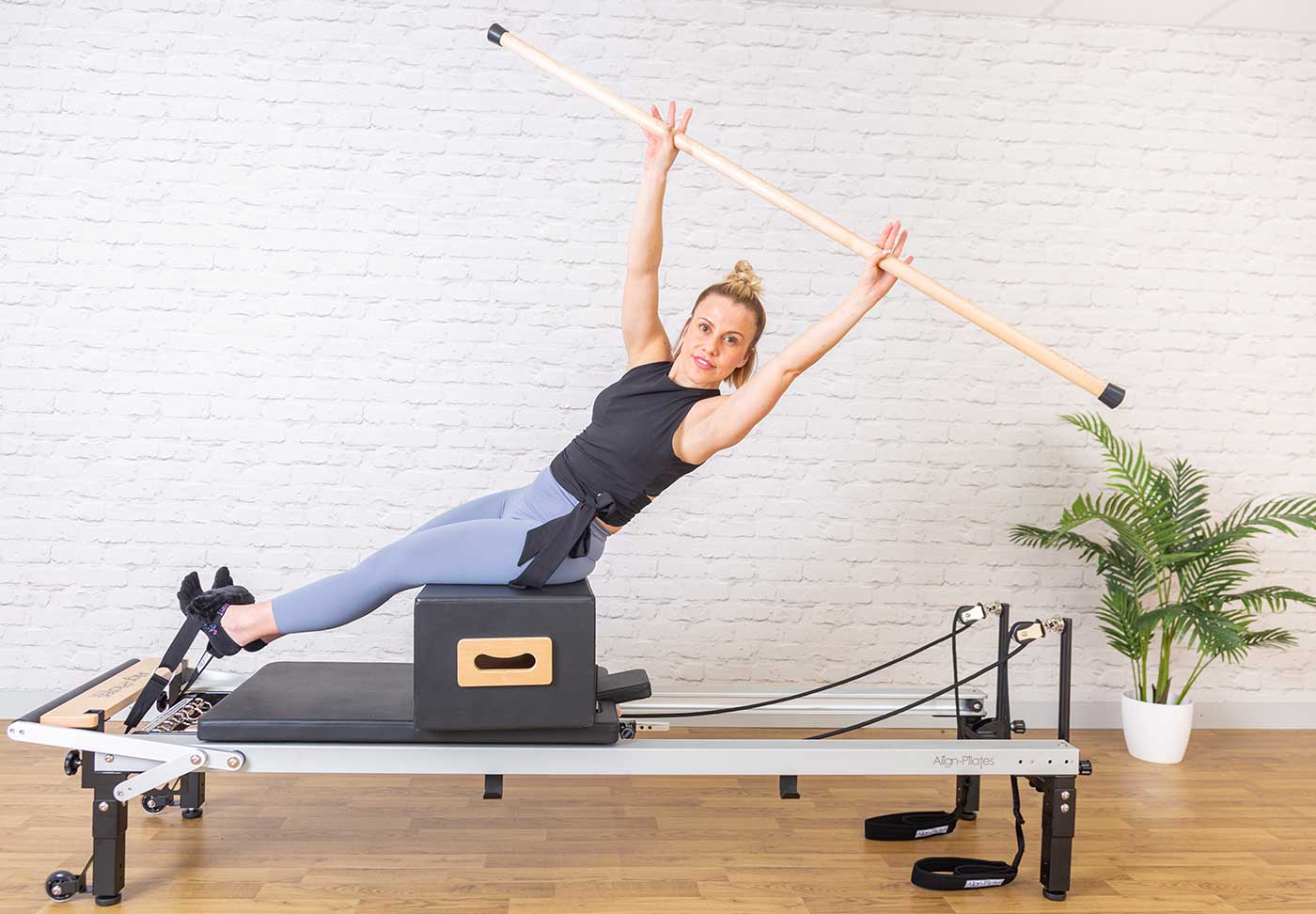 Pilates instructor using Gondola Maple Pole